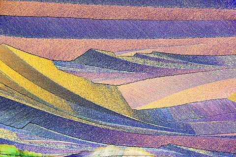Photo through a microscope of crystals growing from the melt of sulfur