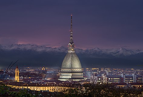 Mole Antonelliana in Turin by night. Alps in the background.