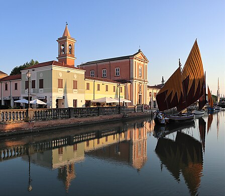 Saint James the Apostle Parish Church and historic boats in the Porto Leonardesco, Cesenatico (Italy).