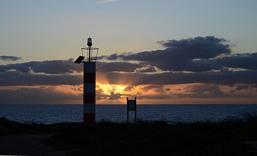Setting sun and crepuscular rays in Porto Covo, west coast of Portugal