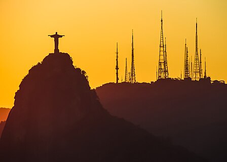 Rio de Janeiro’s Christ the Redeemer statue seen from Sugarloaf Mountain during sunset.